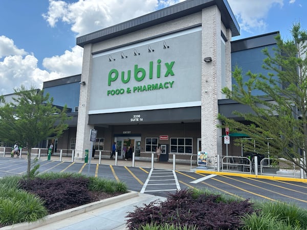 Shoppers at a newly built Publix on Piedmont Road in Buckhead talk Sunday, June 22, 2025, about President Donald Trump's strike on Iran nuclear sites. (David Aaro/AJC)