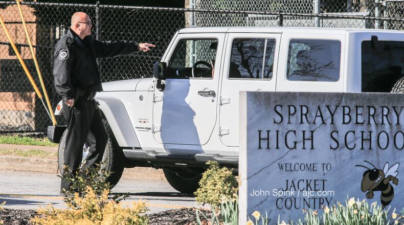 A school resource officer is posted outside of Sprayberry High School in 2020. (JOHN SPINK / AJC)