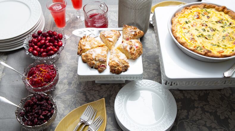 These recipes prove that cranberries aren't just for Thanksgiving: Dried Cranberries (bottom left), Chunky Cranberry Sauce with Walnuts and Ginger (middle left), beverages with Cranberry Ginger Syrup (upper left), Cranberry Scones (center) and Sweet Potato and Cranberry Quiche (right). (Styling by C.W. Cameron / Martha Williams for the AJC)