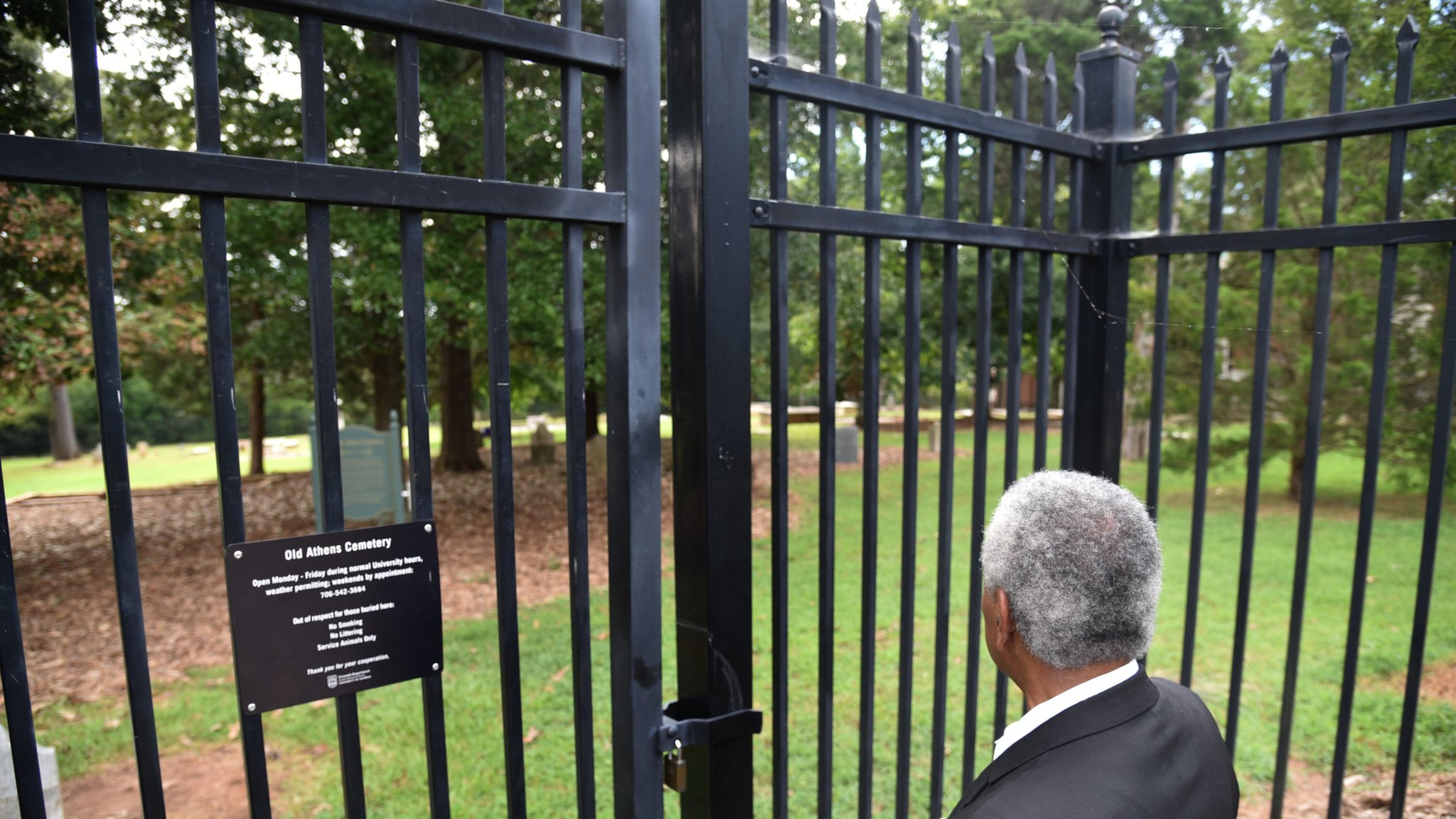 Fred Smith, co-chair of Athens Area Black History Committee, looks toward Old Athens Cemetery near Baldwin Hall on University of Georgia campus. The discovery of 19th century African American remains in an area near the cemetery on UGA’s campus three years ago forced an examination of the history of slavery at the nation’s oldest land grant institution. (Hyosub Shin/AJC)