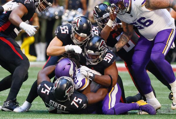 Minnesota Vikings running back Alexander Mattison (2) is stopped short of a first down by Atlanta Falcons linebacker Kaden Elliss (55), defensive tackle Kentavius Street (75) and defensive tackle David Onyemata (90) during the first half of an NFL football game In Atlanta on Sunday, Nov. 5, 2023 between the Atlanta Falcons and the Minnesota Vikings. (Bob Andres for the Atlanta Journal Constitution)
