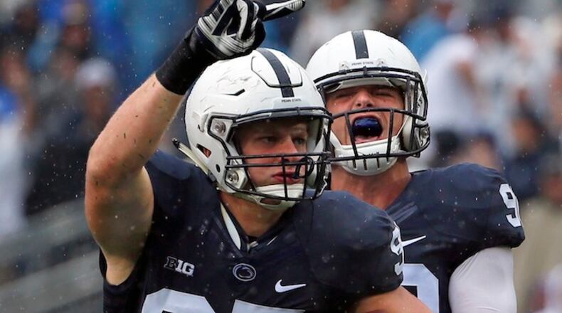 FILE - In this Saturday, Sept. 12, 2015, file photo, Penn State defensive end Carl Nassib (95) celebrates his second half interception with defensive end Garrett Sickels (90) during an NCAA college football game against Buffalo in State College, Pa. Nassib has been named to the AP All-America football team. (AP Photo/Gene J. Puskar, File)