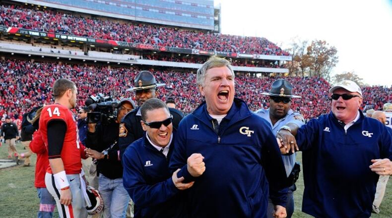 Georgia Tech head coach Paul Johnson, center, shouts and clenches his fist after Georgia quarterback Hutson Mason (14) threw an interception to Tech's D.J. White during overtime to preserve a 30-24 win in an NCAA college football game Saturday, Nov. 29, 2014, in Athens, Ga. (AP Photo/David Tulis) Paul Johnson engineered an upset of Georgia and the ACC Coastal Division title. (AP photo)