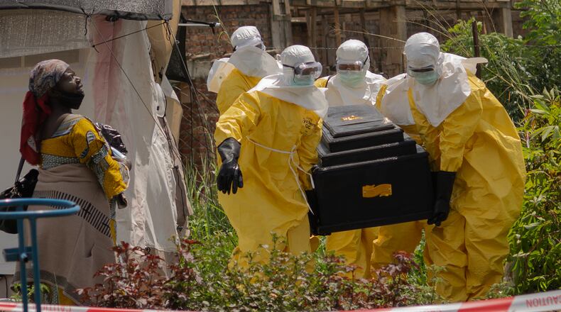 A woman cries as Red Cross workers carry the coffin of a person who died of Ebola from a health center in Rwampara, Congo, Wednesday, May 20, 2026. (AP Photo/Moses Sawasawa)