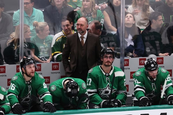 Dallas Stars head coach Peter DeBoer stands behind players on the bench during the second period of Game 5 of the Western Conference finals in the NHL hockey Stanley Cup playoffs against the Edmonton Oilers, Thursday, May 29, 2025, in Dallas. (AP Photo/Gareth Patterson)