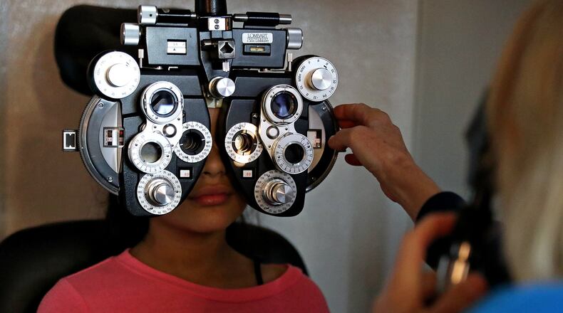 Anna Stalcup administers a vision test to Amanda Luna,11, (left) at the Seton Medical Mission at Seton Medical Center Hays on Saturday January 28, 2017. Daulton Venglar/AMERICAN-STATESMAN