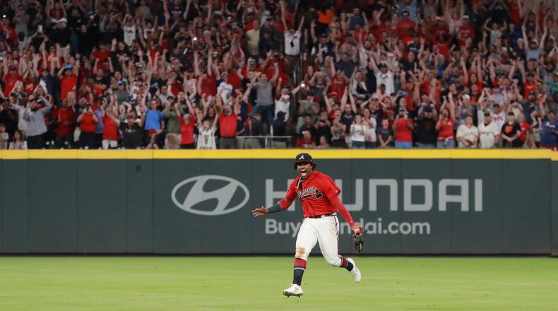 Outfielder Ronald Acuna and Braves fans begin to celebrate after he catches a fly ball for the final out to clinch the National League East title on Friday.