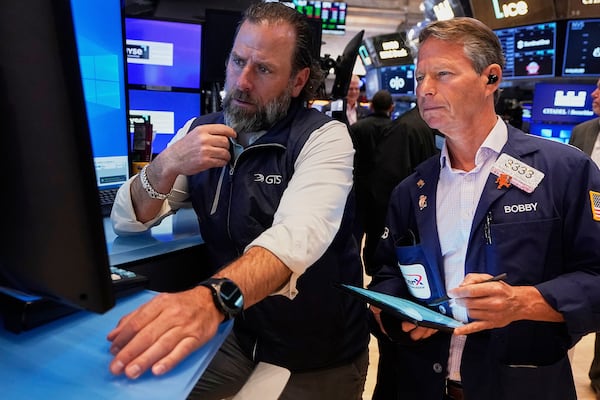 Specialist Michael Pistillo, left, and trader Robert Charmak work on the floor of the New York Stock Exchange, Tuesday, June 3, 2025. (AP Photo/Richard Drew)