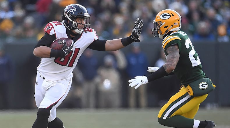 Austin Hooper of the Atlanta Falcons stiff arms Josh Jones of the Green Bay Packers during the first half of a game at Lambeau Field on December 09, 2018 in Green Bay, Wisconsin. (Photo by Stacy Revere/Getty Images)