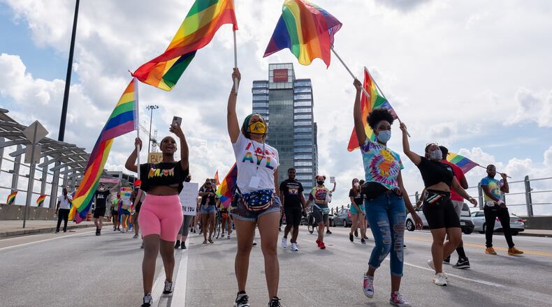 FILE: Dee Dee Tsegaye, from left, Andané Browne and Destiny Britt lead the Beauty In Colors Rally and march across the 17th Street bridge on June 28, 2020. (Photo Courtesy of Ben Gray/Atlanta Journal-Constitution)