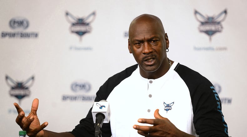 In this file photo, Charlotte Hornets owner Michael Jordan responds to a question during a news conference on Oct. 28, 2014, at Time Warner Cable Arena in Charlotte, North Carolina. Jordan and NASCAR driver Denny Hamlin are starting a NASCAR team, with Bubba Wallace behind the wheel. (Jeff Siner/The Charlotte Observer/TNS)
