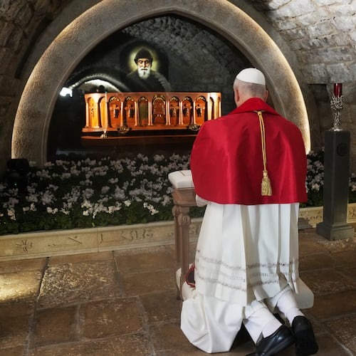 Pope Leo XIV prays in front of the tomb of Saint Charbel Makhlouf at the Monastery of Saint Maroun, in Annaya, Lebanon, Monday, Dec. 1, 2025. (AP Photo/Domenico Stinellis, Pool)