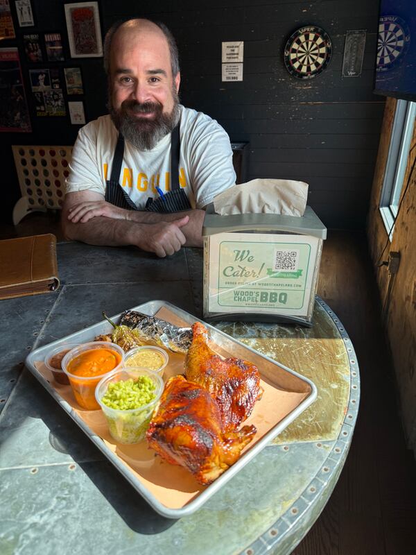 Chef and restaurant partner Todd Ginsberg with a new menu item at Wood's Chapel BBQ, the chicken al carbon served with 3 flour tortillas, cilantro rice, cowboy beans and onion. (Courtesy of Wood's Chapel BBQ)