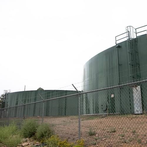 Reserve water tanks for holding drinking water for Grand Canyon Village stand behind fencing, Monday, Aug. 31, 2026, in Grand Canyon National Park, Ariz. (AP Photo/Josh Biggs)