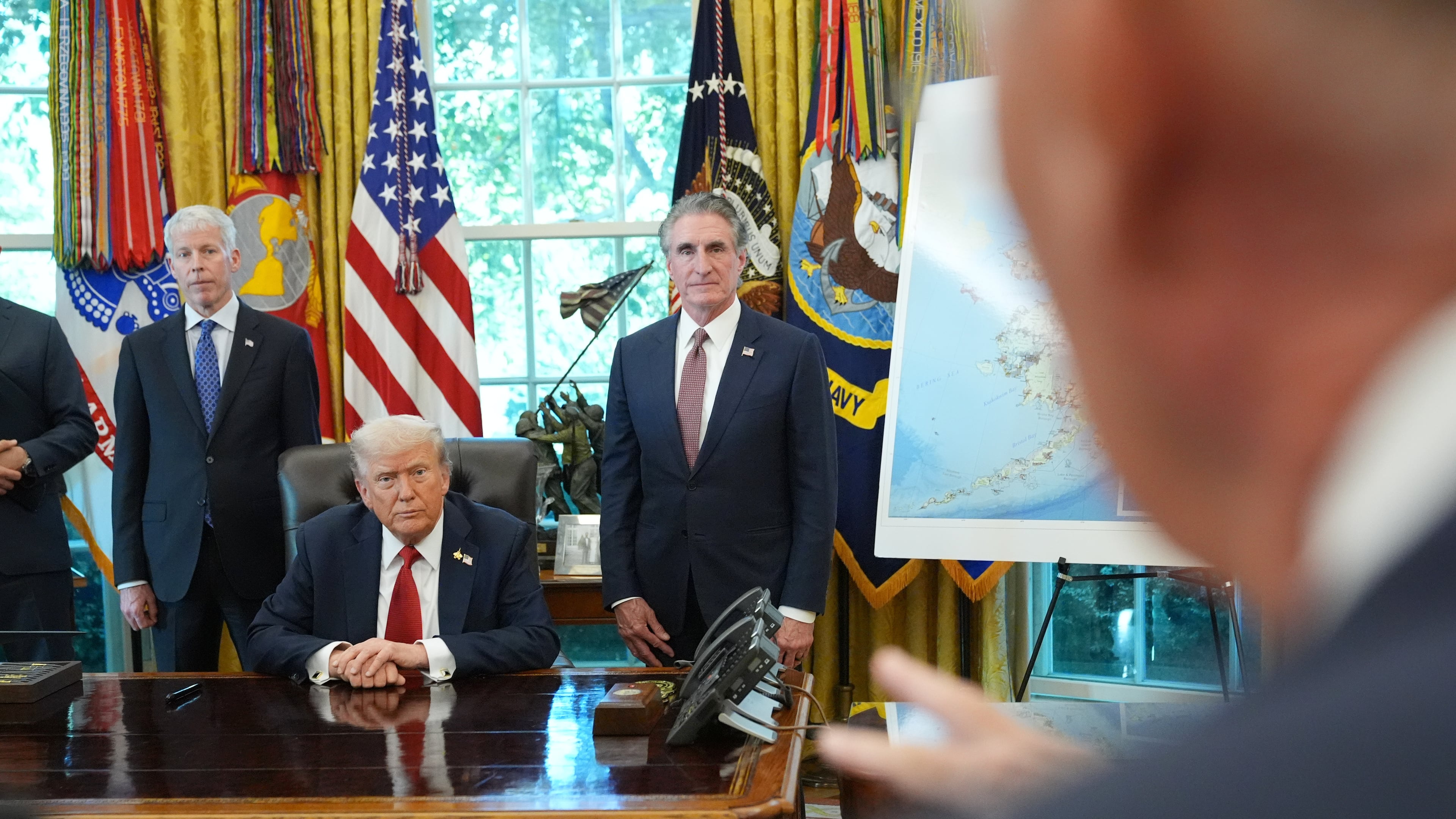 President Donald Trump speaks to reporters before signing an executive order in the Oval Office at the White House, Monday, Oct. 6, 2025, in Washington, as Energy Secretary Chris Wright and Interior Secretary Doug Burgum listen. (AP Photo/Jacquelyn Martin)