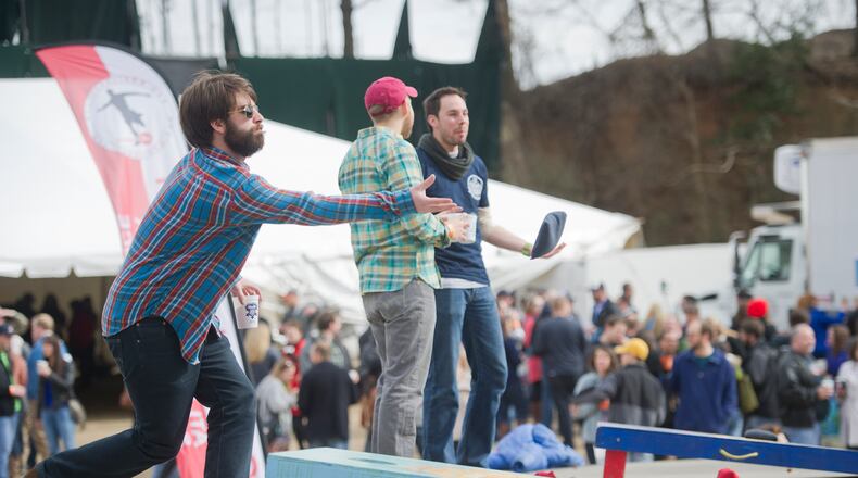 Jason Furst (left), Korey Phelps and Chevas Yeoman play cornhole. JONATHAN PHILLIPS / SPECIAL