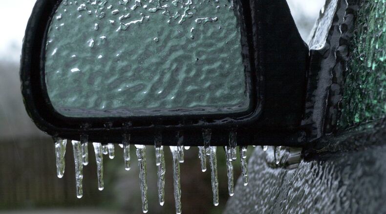 Freezing rain has completely frozen over this side view mirror on a vehicle in a Rockdale County driveway off Hwy 138 in Conyers, Ga., at dusk on Saturday, Jan. 29, 2000. (CURTIS COMPTON/staff)