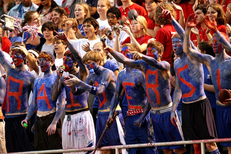 Riverwood students spell out "Raiders" in war paint while cheering for their team. The school has parted ways with football coach Shawn Cahill after a 5-25 run over three seasons.