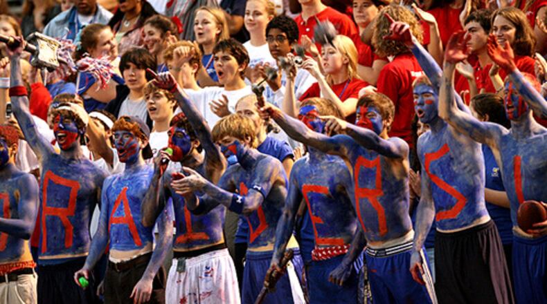 Riverwood students spell out "Raiders" in war paint while cheering for their team. The school has parted ways with football coach Shawn Cahill after a 5-25 run over three seasons.