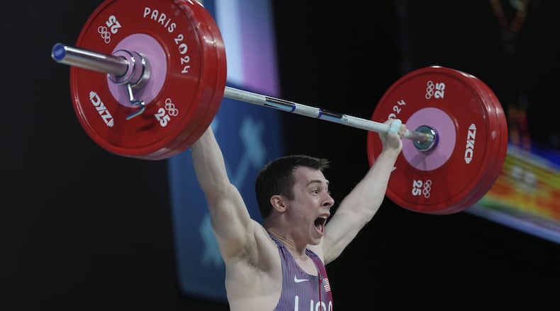 Hampton Morris of the United States competes during the men's 61kg weightlifting event at the 2024 Summer Olympics, Wednesday, Aug. 7, 2024, in Paris, France. (AP Photo/Kin Cheung)