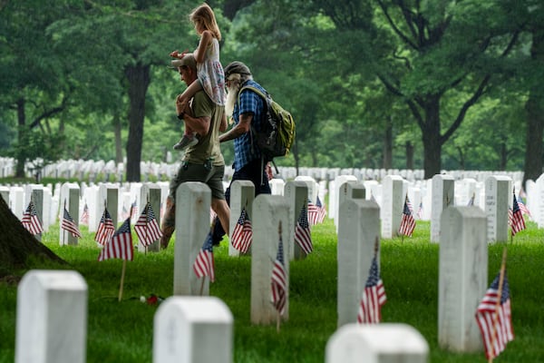 FILE - Families visit Section 60 of Arlington National Cemetery, in Arlington, Va., Monday, May 27, 2024, in honor of Memorial Day. (AP Photo/Jacquelyn Martin, File)