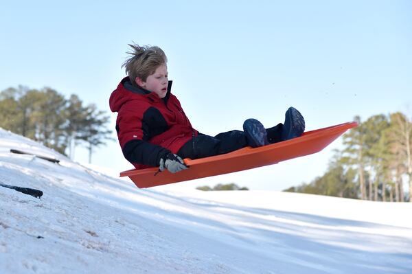 January 7, 2017, Alpharetta - Matthew Bradburn, 8, sleds down a hill in Alpharetta, Georgia, on Saturday, January 7, 2017. Most of Central and North Georgia woke up to snow and ice following a winter storm warning. (DAVID BARNES / DAVID.BARNES@AJC.COM)