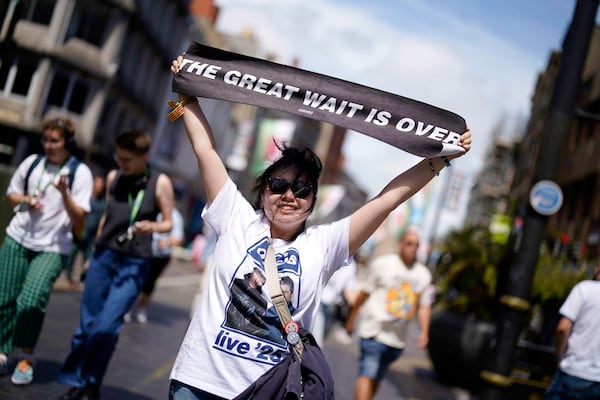 An Oasis fan holds up a banner ahead of the first show in their long-awaited reunion tour which kicks off at the Principality Stadium, in Cardiff, Friday, July 4, 2025. (Jordan Pettitt/PA via AP)