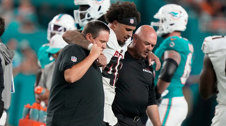 Atlanta Falcons linebacker Bralen Trice (48) is assisted off the field during the first half of a preseason NFL football game against the Miami Dolphins, Friday, Aug. 9, 2024, in Miami Gardens, Fla. (AP Photo/Lynne Sladky)