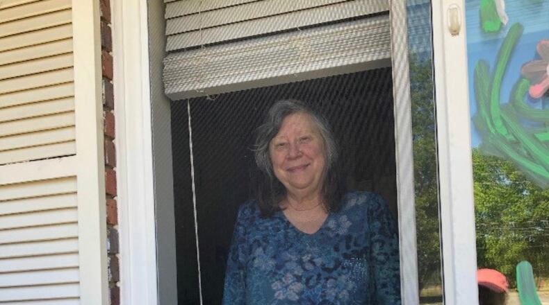In this file photo, Marsha Tyson spends a window visit with her family on Mother's Day weekend at her nursing home in Dublin. Tyson has early-onset Alzheimer's disease and has forgotten her three children over the months of isolation and lockdown.