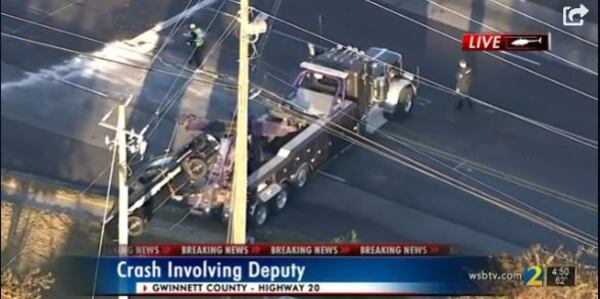 The deputy crashed into a utility pole after swerving around another driver who pulled out in front of him Monday afternoon, authorities said.