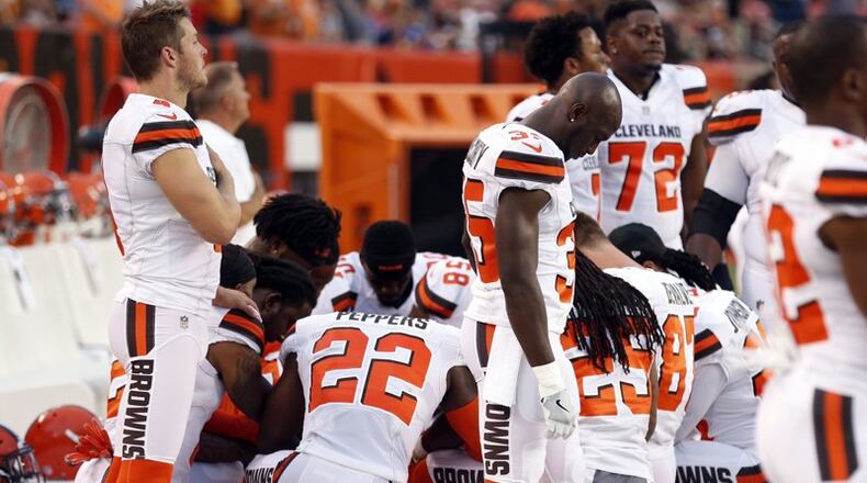Members of the Cleveland Browns kneel before Monday night's NFL exhibition game.