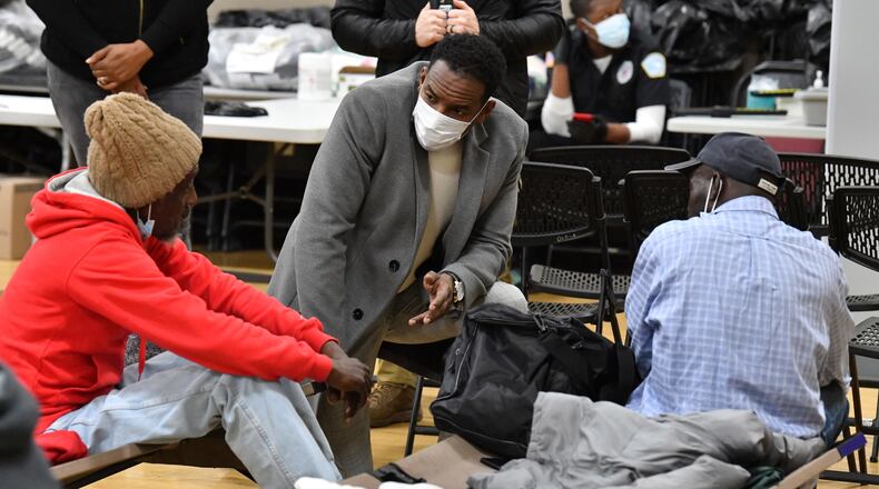 December 22, 2022 Atlanta -  Atlanta mayor Andre Dickens talks to clients as he visits the Old Adamsville Recreation Center warming center in Atlanta on Thursday, December 22, 2022. The City of Atlanta recently announced to open multiple warming centers as temperatures drop across metro Atlanta.  (Hyosub Shin / Hyosub.Shin@ajc.com)