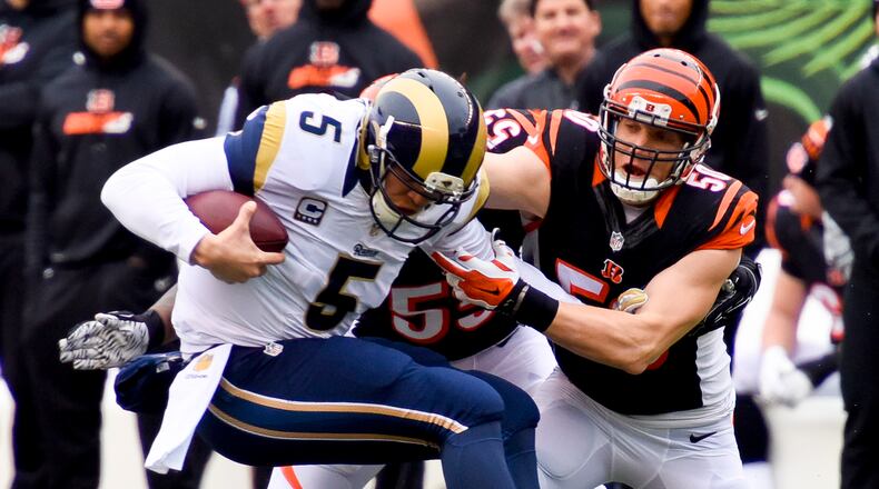 Cincinnati Bengals linebacker A.J. Hawk takes down St. Louis Rams quarterback Nick Foles during their 31-7 win over the Rams Sunday, Nov. 29 at Paul Brown Stadium in Cincinnati. NICK GRAHAM/STAFF