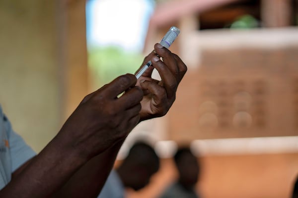 FILE - Health officials prepare to administer a vaccine in the Malawi village of Tomali with the world's first vaccine against malaria in a pilot program in Tomali, Dec. 11, 2019. (AP Photo/Jerome Delay, File)