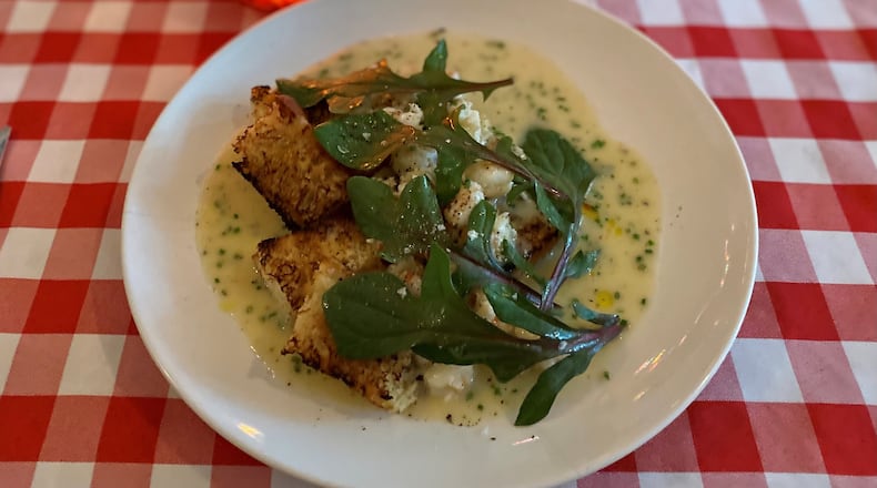 Gigi’s Italian Kitchen & Restaurant sometimes riffs on classics — like this shrimp scampi with focaccia and red-veined spinach. Wendell Brock for The Atlanta Journal-Constitution
