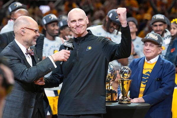 Indiana Pacers head coach Rick Carlisle, center, celebrates after his team won Game 6 of the Eastern Conference finals of the NBA basketball playoffs against the New York Knicks in Indianapolis, Saturday, May 31, 2025. (AP Photo/Michael Conroy)