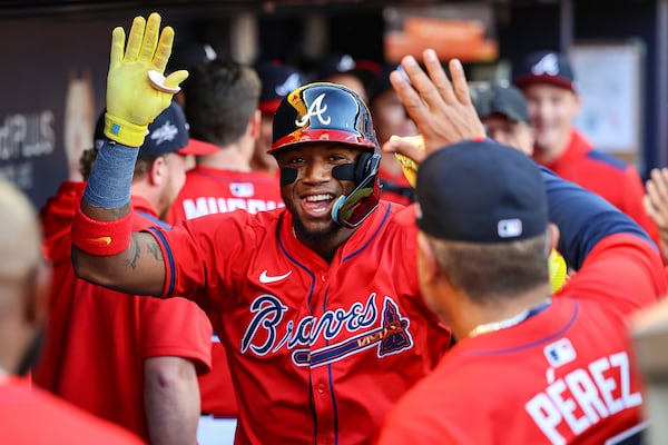 Atlanta Braves' Ronald Acuna Jr. celebrates in the dugout after hitting a home run in the first inning of a baseball game against the San Diego Padres, Friday, May 23, 2025, in Atlanta. (AP Photo/Colin Hubbard)