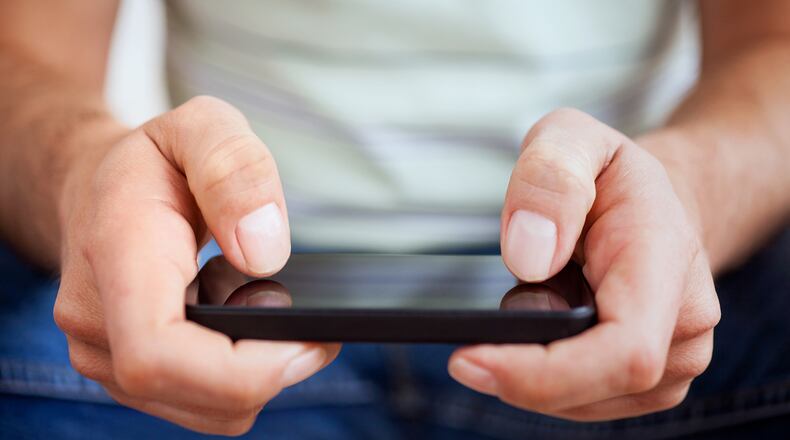 Hands of a person using a smartphone