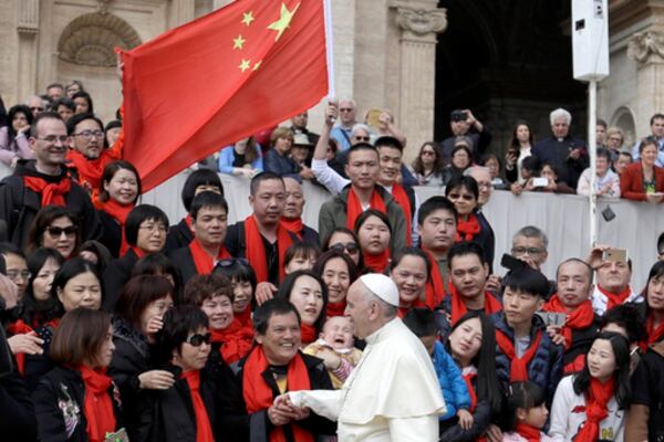 FILE - In this April 18, 2018 file photo, Pope Francis meets a group of faithful from China at the end of his weekly general audience in St. Peter's Square, at the Vatican. The Vatican on Tuesday, Sept. 29, 2020, answered its critics and justified its decision to pursue an extension of an agreement with China over bishop nominations, acknowledging difficulties but insisting that limited, positive results had been achieved.(AP Photo/Gregorio Borgia, file)