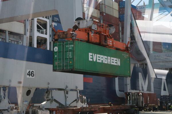 A container is lifted off a trailer to be loaded onto a cargo ship at the Georgia Ports Authority Garden City Terminal.