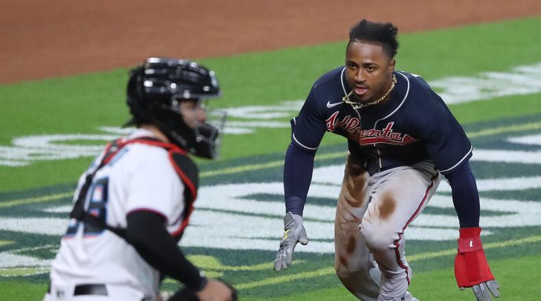Braves' Ozzie Albies goes into home past Miami Marlins catcher Jorge Alfaro for a 6-0 lead on a Dansby Swanson RBI-single during the fifth inning in Game 3 of a National League Division Series at Minute Maid Park on Thursday, Oct 8, 2020 in Houston.   “Curtis Compton / Curtis.Compton@ajc.com”