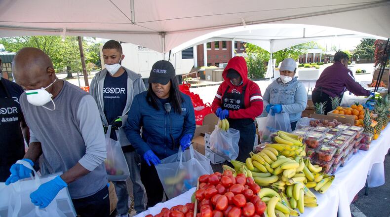 Volunteers assemble food bags before the start of the City of College Park Recreation and Cultural Arts Department's first pop-up grocery store in College Park Saturday, April 18, 2020. STEVE SCHAEFER / SPECIAL TO THE AJC