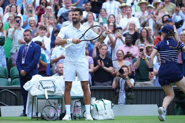 Novak Djokovic of Serbia does a dance as he celebrates beating Miomir Kecmanovic of Serbia during a third round men's singles match at the Wimbledon Tennis Championships in London, Saturday, July 5, 2025. (AP Photo/Kirsty Wigglesworth)