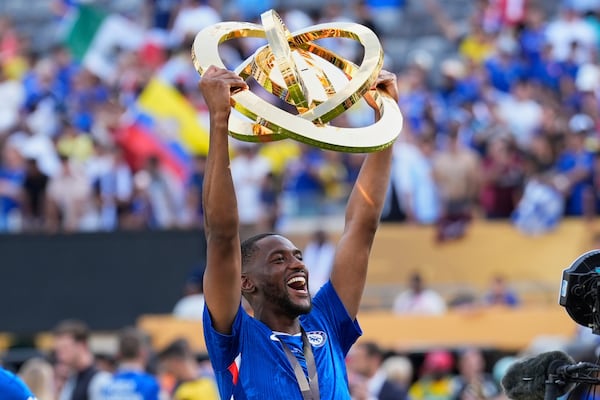Chelsea's Tosin Adarabioyo hold throphy after the Club World Cup final soccer match between Chelsea and PSG in East Rutherford, N.J., Sunday, July 13, 2025. (AP Photo/Chris Szagola)