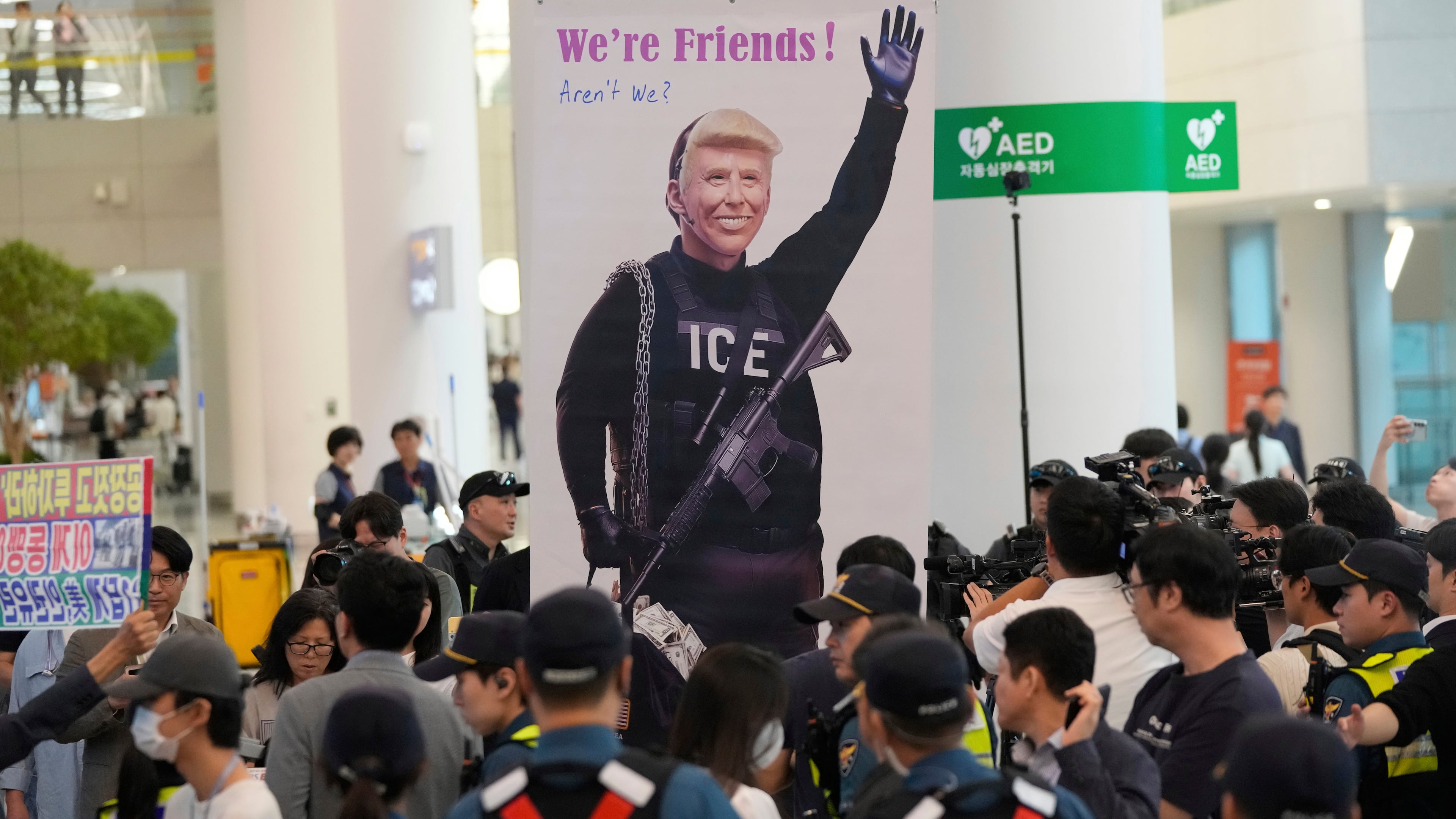 A banner depicting U.S. President Donald Trump is seen at the arrival terminal of the Incheon International Airport, in Incheon, South Korea, Friday, Sept. 12, 2025. (Ahn Young-joon/AP)