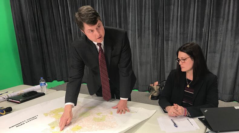 Gwinnett Departmentof Transportation Director Alan Chapman discusses the county's comprehensive transit plan during a Thursday media briefing as consultant Cristina Pastore looks on. TYLER ESTEP / TYLER.ESTEP@AJC.COM