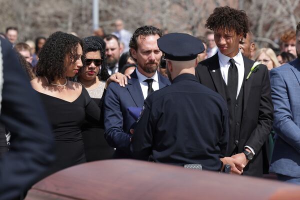 The children and widow of former U.S. Rep. Mia Love, from left, Alessa, Jason, and Peyton, are given the U.S. flag that was draped on her casket during the memorial service at The Church of Jesus Christ of Latter-day Saints on the University of Utah campus in Salt Lake City, Monday, April 7, 2025. (AP Photo/Melissa Majchrzak)