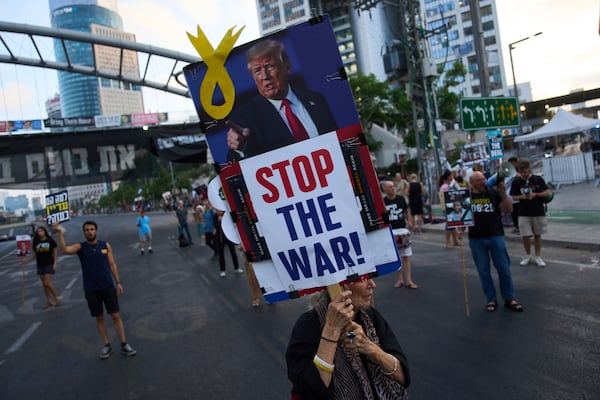 Relatives of hostages held by Hamas in the Gaza Strip and their supporters call for an immediate hostage release deal during a protest in Tel Aviv, Israel, Thursday, July 10, 2025. (AP Photo/Ariel Schalit)