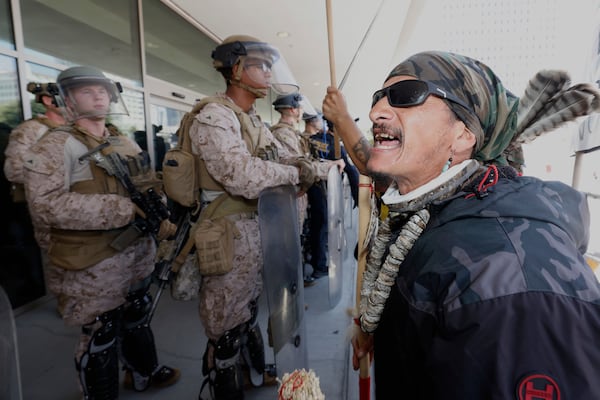 Protesters confront Marines outside the Federal Building on Friday, July 4, 2025 in Los Angeles. (AP Photo/Jill Connelly)