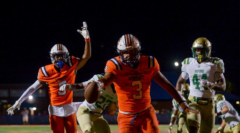 North Cobb quarterback Malachi Singleton scores in the second half of Friday's game against Buford. (Daniel Varnado/Special to the AJC)